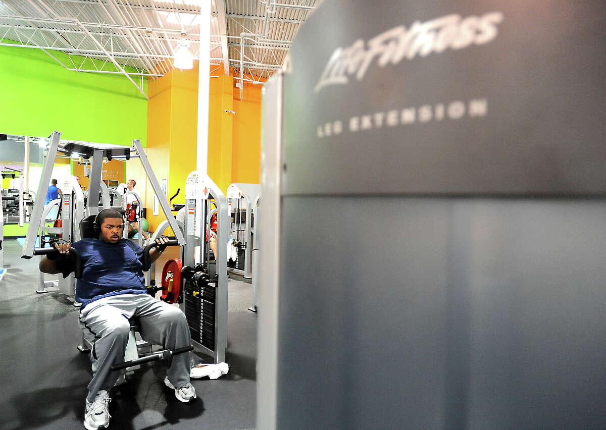 Willie Gillis III works out at Exygon Health and Fitness Club in Beaumont in Beaumont, Thursday, April 12, 2012. Gillis has lost 230 pounds through diet and exercise. Tammy McKinley/The Enterprise