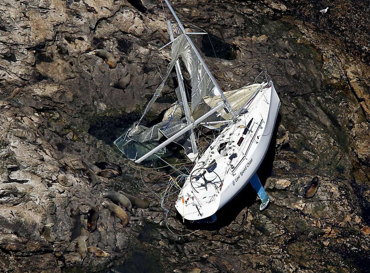 Surrounded by seals and sea lions, the sailing vessel Low Speed Chase lay on its side on the Farallon Islands Monday April 16, 2012. Five people lost their lives during a race Saturday.