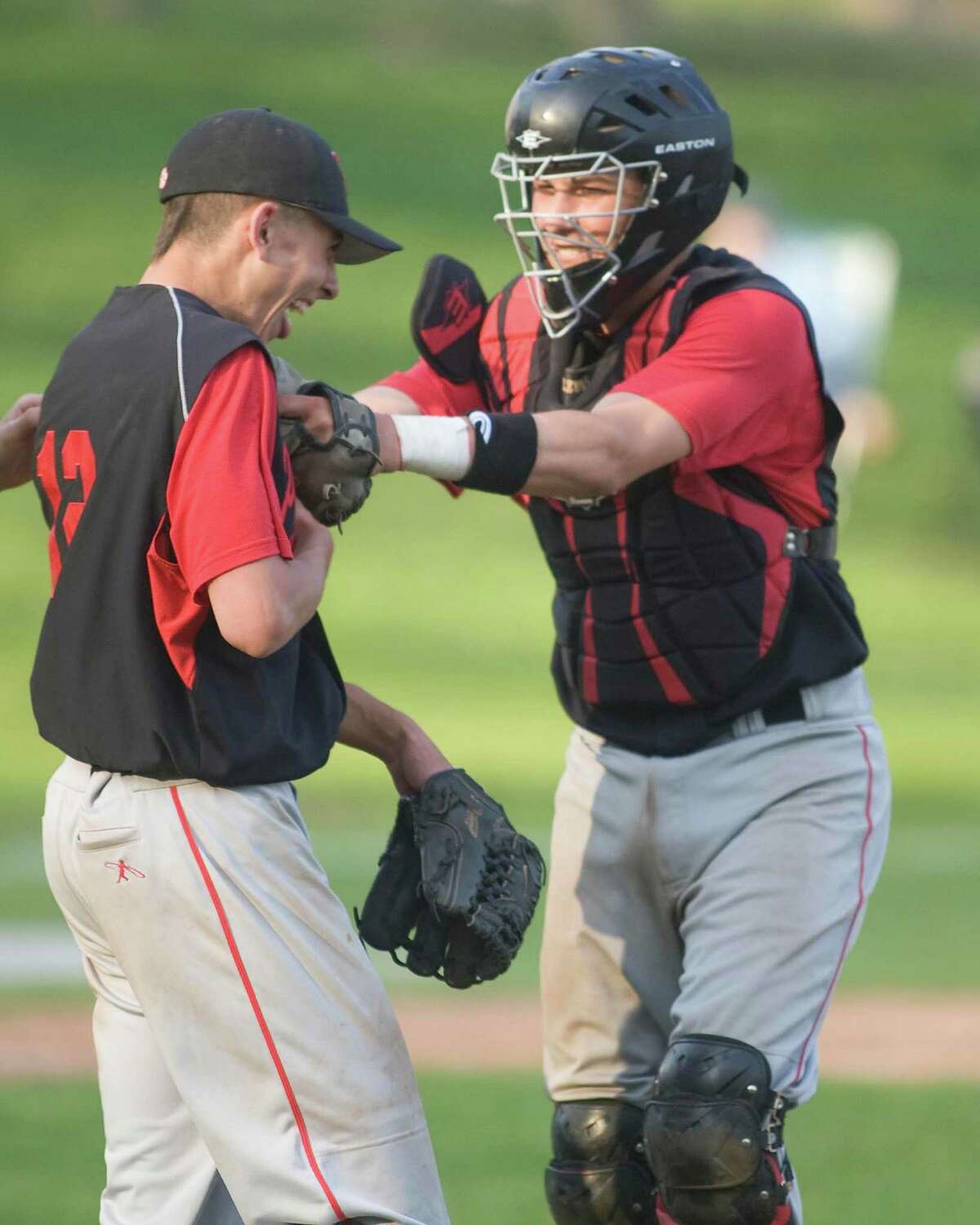 Pomperaug's David Cherry receives congratulations from catcher Matt Calzone after pitching a no-hitter against Immaculate Monday in Danbury.