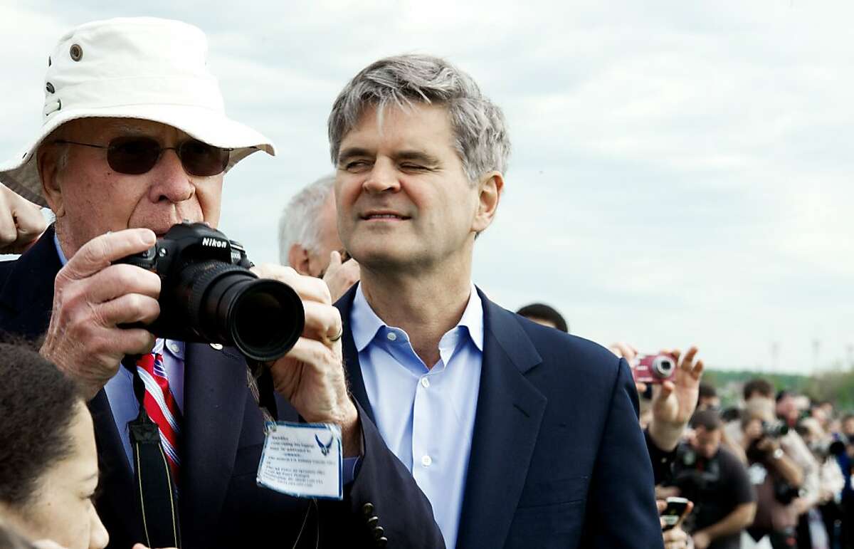 US Senator Patrick LeahyD-VA snaps photos as former AOL Chairman & CEO Steve Case(R) watch the Space Shuttle Discovery and NASA's Boeing 747 Shuttle Carrier Aircraft(SCA) land at Washington, Dulles International Airport April 17, 2012. The shuttle is on it's way to it's new permanent display at the Smithsonian National Air and Space Museum's Steven F. Udvar-Hazy Center in Chantilly, Virginia. AFP Photo/Paul J. Richards (Photo credit should read PAUL J. RICHARDS/AFP/Getty Images)