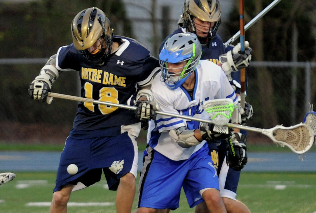 Bunnell's #7 Andrew Calzone, right, and Notre Dame of Fairfield's #18 Cooper Demchak go after the ball, during boys lacrosse action in Stratford, Conn. on Tuesday April 17, 2012.