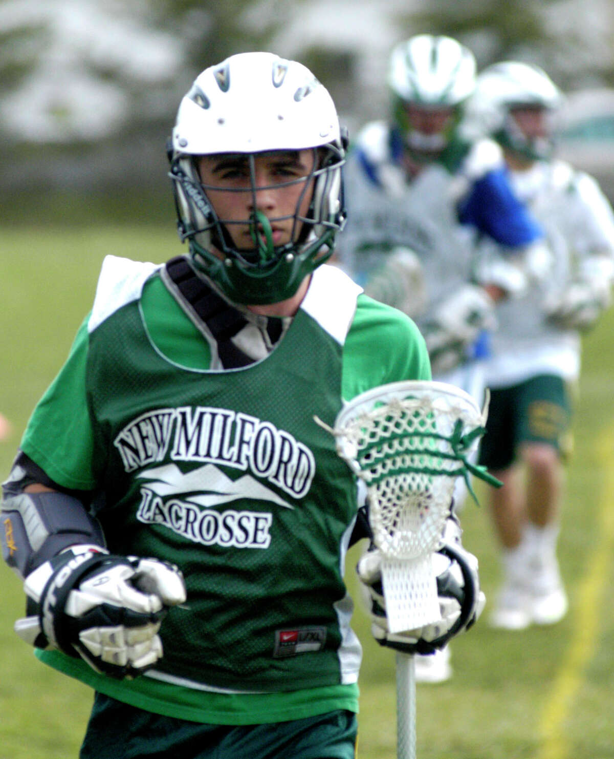 SPECTRUM/Green Wave sophomore Andrew McGuire keeps pace during a pre-season drill for New Milford High School boys' lacrosse, April, 2012