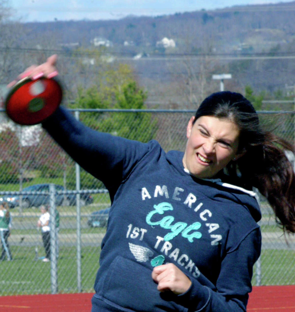 SPECTRUM/Shannon Cronwell of the Green Wave preps with the discus for the New Milford High School girls' track campaign, April, 2012