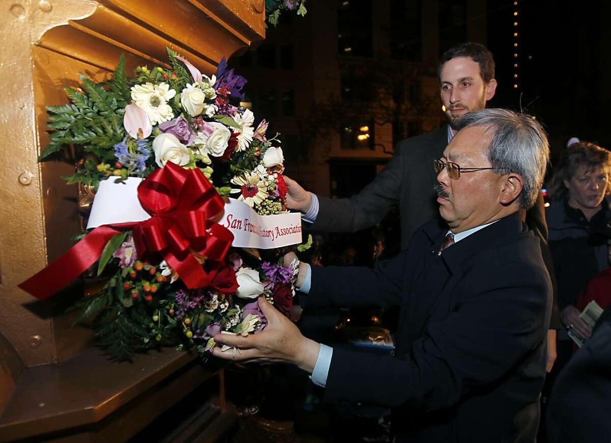 Mayor Ed Lee and Supervisor Scott Wiener place a memorial wreath on Lotta's Fountain to mark the 106th anniversary of the 1906 earthquake in San Francisco, Calif. on Wednesday, April 18, 2012.