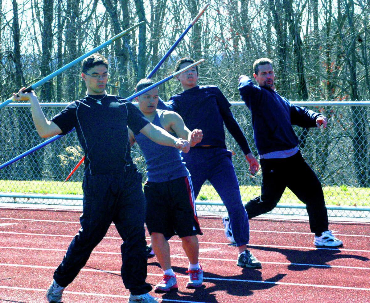 SPECTRUM/Coach Tom Scarola works with Spartan javelin hopefuls, from left to right, Matt Stager, Vinny Collins and David Geyer, for Shepaug Valley High School boys' track. April 2012
