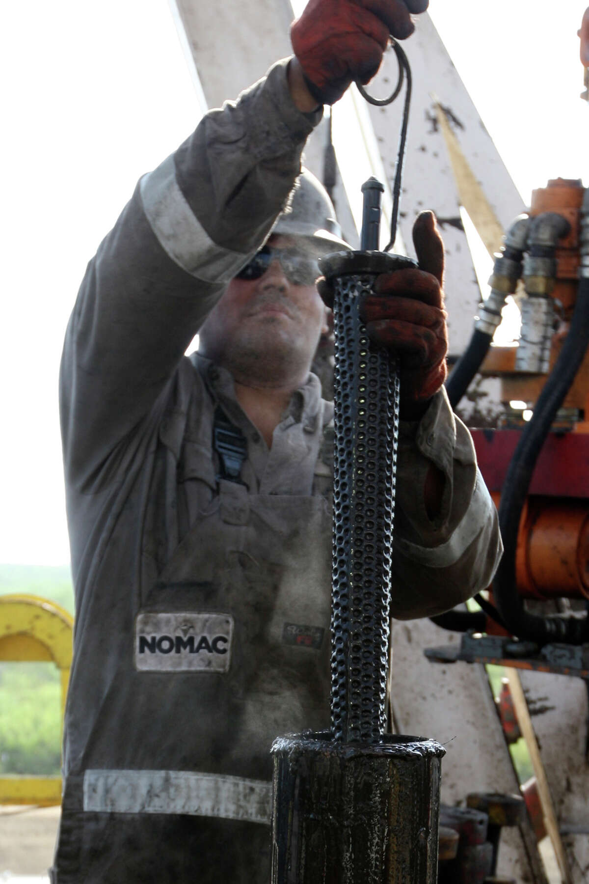METRO -- Floorhand, Draden Copepland, cleans a filter on a drilling rig at a site near Carriso Springs on a well owned by Chesapeake Energy, Thursday, April 5, 2012. Jerry Lara/San Antonio Express-News