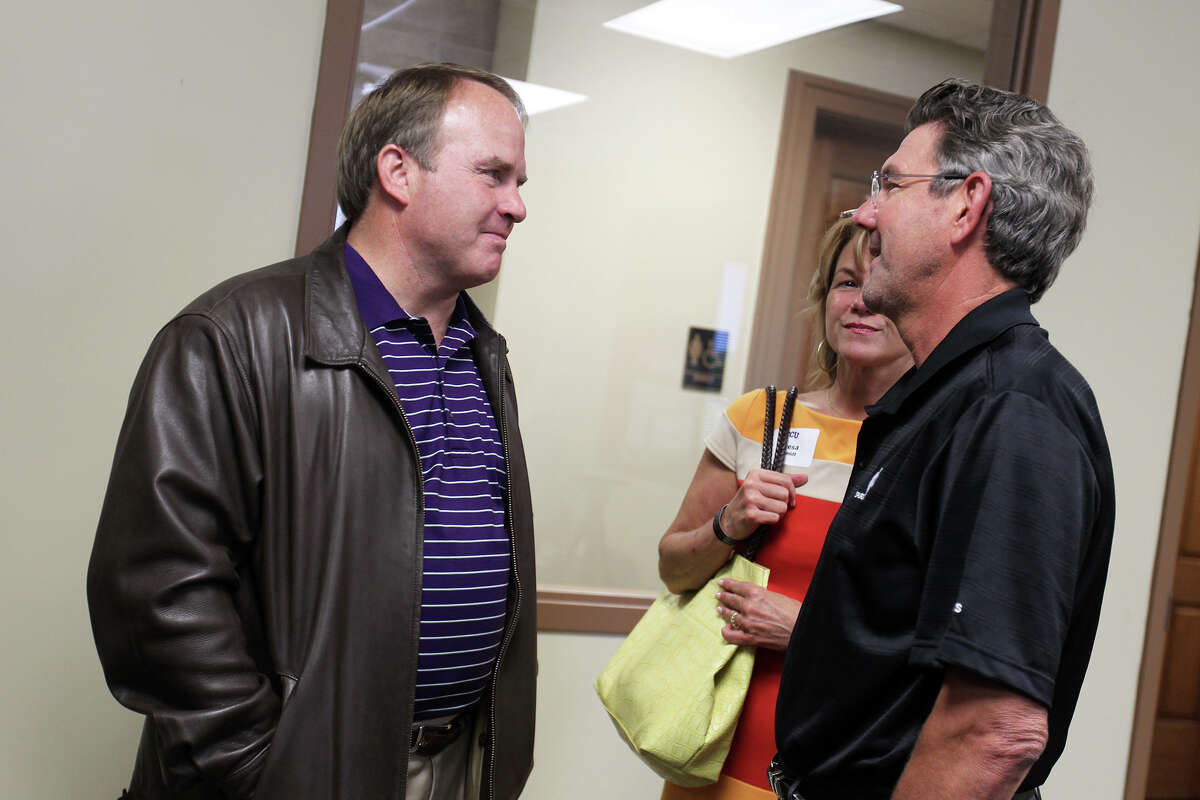 Head football coach Gary Patterson speaks with Dr. David Schmidt and his wife, Teresa, before a TCU boosters luncheon at Polo Fields Golf Center at Brackenridge Park, Thursday, April 19, 2012.