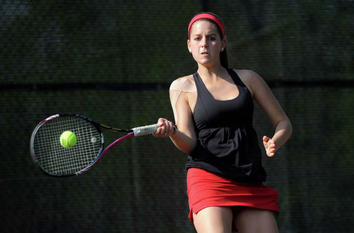 Kristin Laub of New Canaan competes against Greenwich in the first doubles match during Thursday's tennis match at Greenwich High School on April 19, 2012.