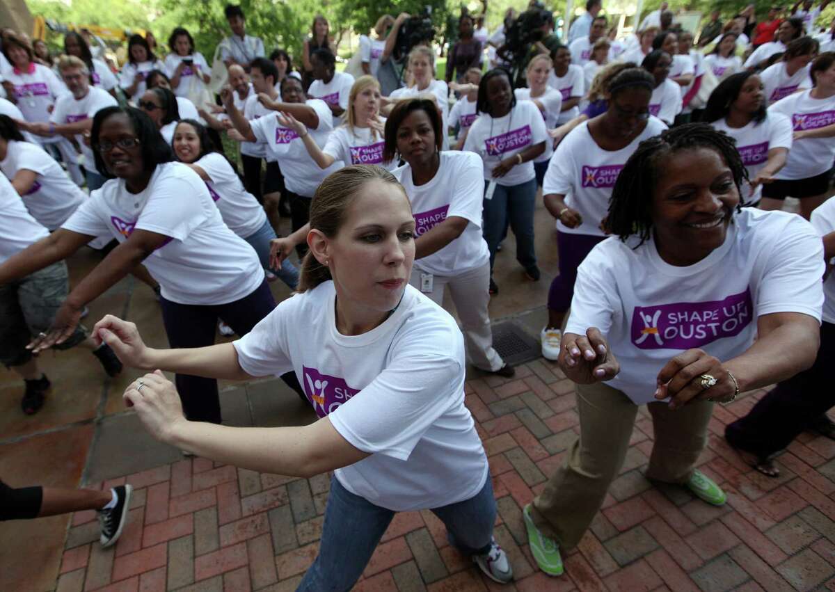 Mary Eckhardt, student at UT Schoo. of Public Health, and Paula Nickerson, RN at MD Anderson Cancer Center, participate in a Flash Mob during the Shape Up Houston kick off event at the John P. McGovern Texas Medical Center Commons on Thursday, April 19, 2012, in Houston. Texas Medical Center institution CEOs and Lan Bentsen unveil Shape Up Houston, an effort to improve the health and wellness of residents through weight loss. The initiative, designed to finally squash the obesity epidemic in Houston.