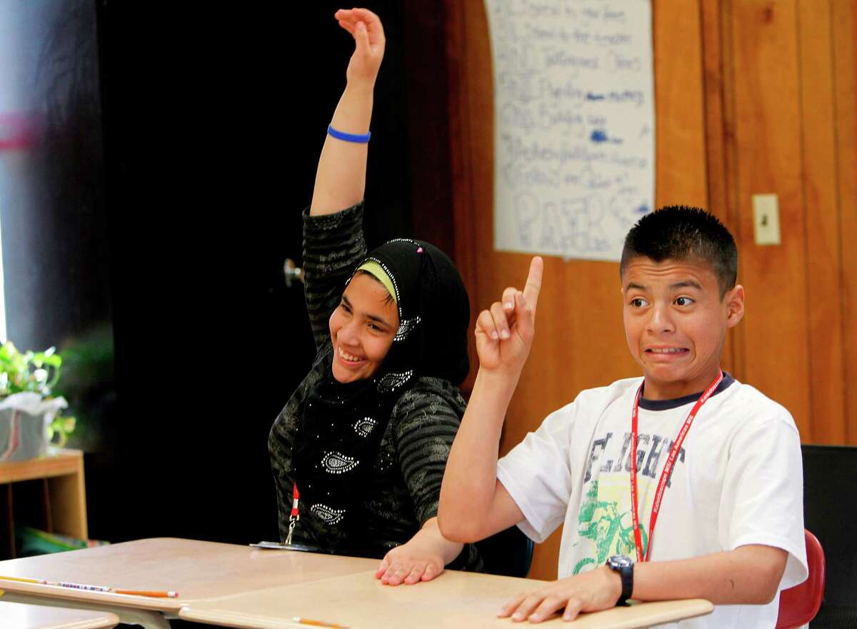 Razqia Al Tuma, from Iraq, and Brayan Rodriguez, from Honduras, compete to answer a question during a vocabulary lesson in the 'self-contained' class at Las Americas Middle School on Thursday, April 12, 2012, in southwest Houston. The self contained class is an elementary style class that helps students acclimate to the U.S. school system for those who have never been to school in their own country or have significant gaps in their schooling.