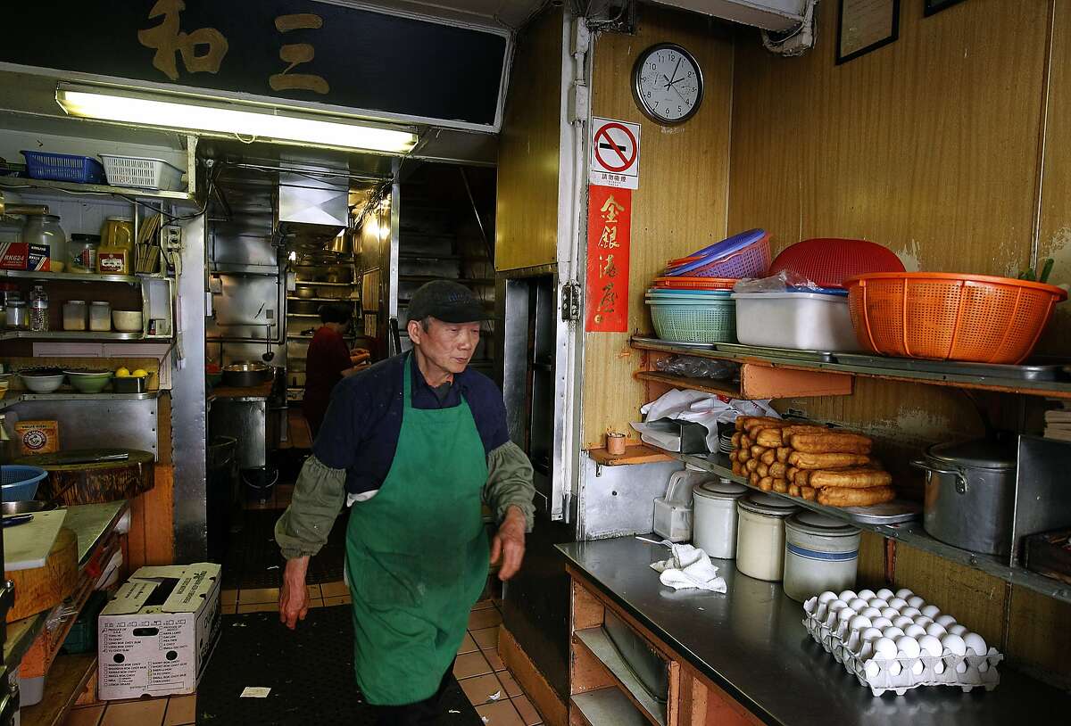 Cook Sen Ren Situ walks through the tiny kitchen of Chinatown's legendary Sam Wo restaurant in San Francisco, Calif. on Thursday, April 19, 2012. The restaurant's owner is closing its doors for good on Friday.