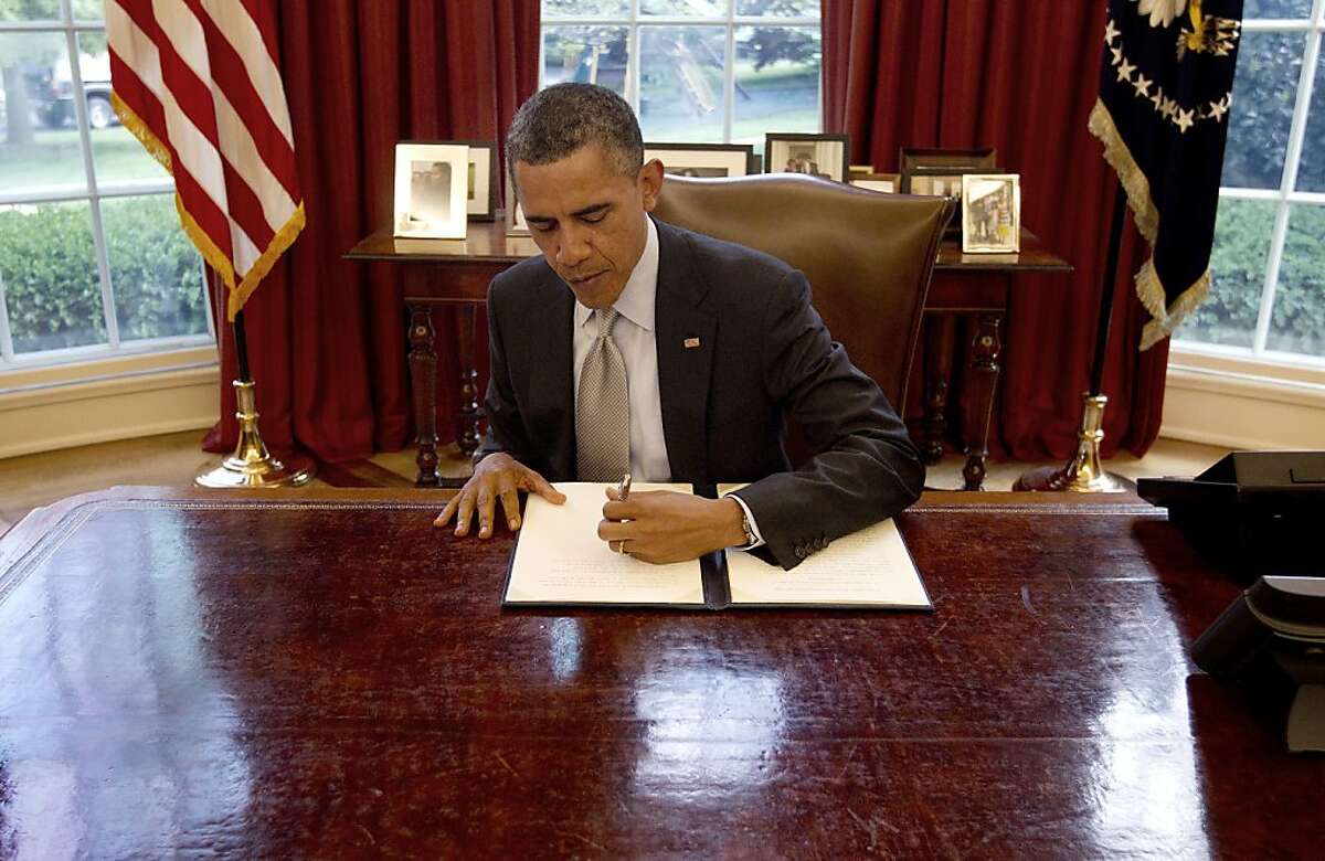 President Barack Obama signs a proclamation in the Oval Office of the White House in Washington, Friday, April 20, 2012, to designate federal lands within Fort Ord, a former military base located on California's Central Coast, as a National Monument under the Antiquities Act. (AP Photo/Pablo Martinez Monsivais)