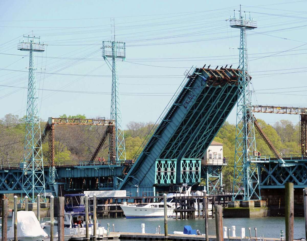 A boat passes under the raised Cos Cob railroad bridge, Thursday afternoon, April 19, 2012. The Cos Cob moveable railroad bridge is more than a century old.