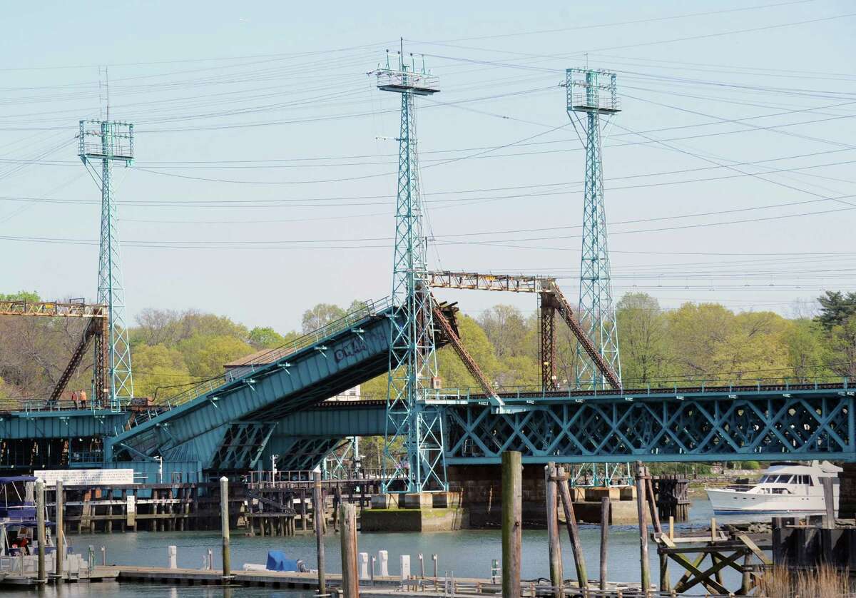 A boat waits for the Cos Cob railroad bridge to be raised before passing through, Thursday afternoon, April 19, 2012. The Cos Cob moveable railroad bridge is more than a century old.