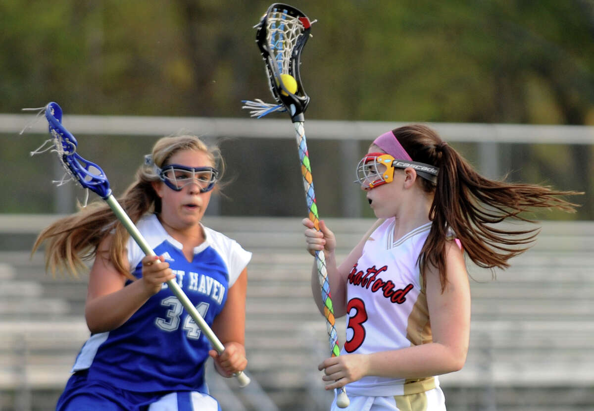 Stratford's #3 Chelsea Barstow, right, looks to drive past West Haven's #34 Ava Gaumbardella, during girls lacrosse action in Stratford, Conn. on Saturday April 21, 2012.