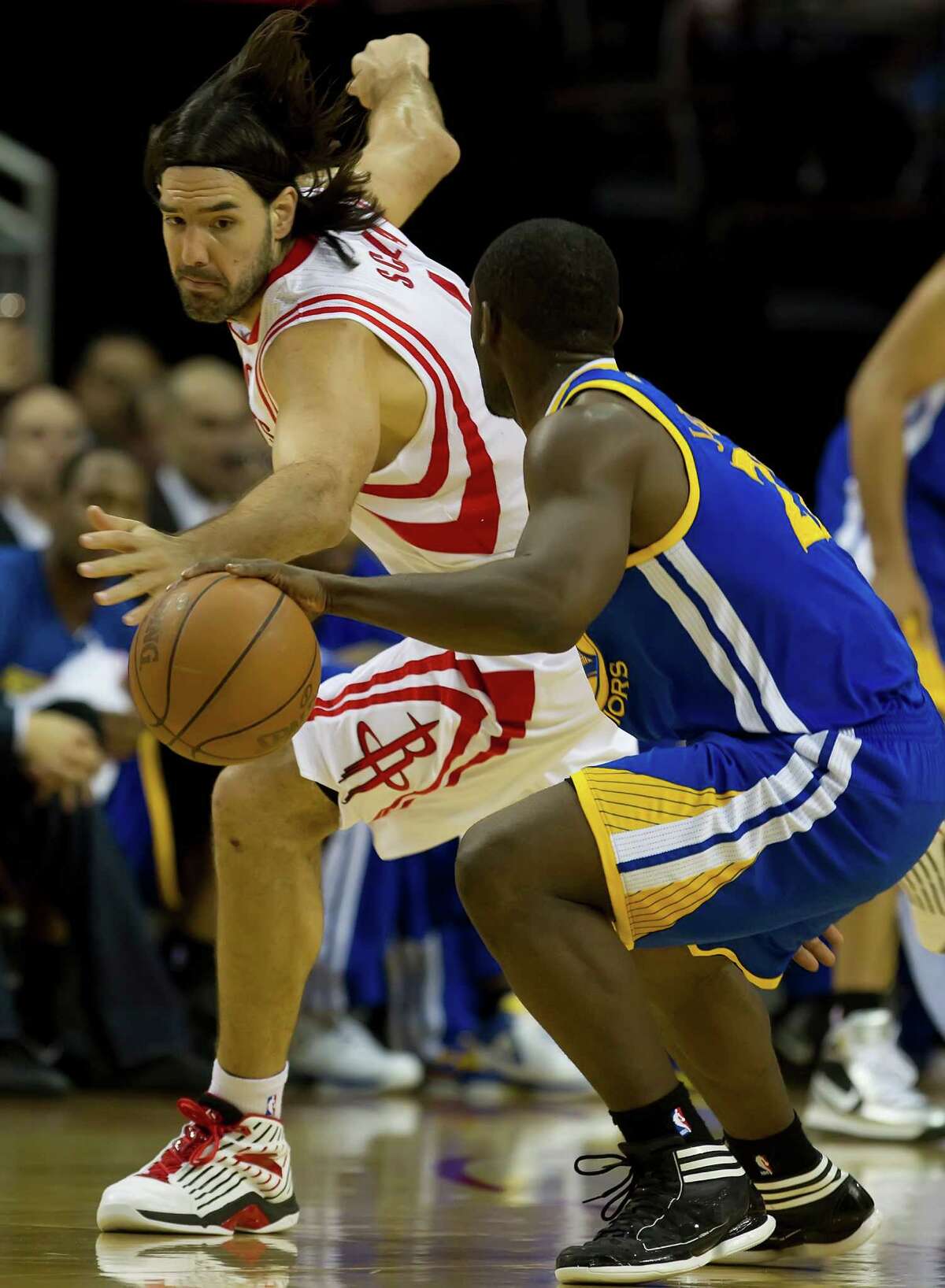 Luis Scola (4) of the Houston Rockets tries to steal the ball from Charles Jenkins (22) of the Golden State Warriors on Saturday, April 21, 2012, in Houston, Texas. (George Bridges/MCT)