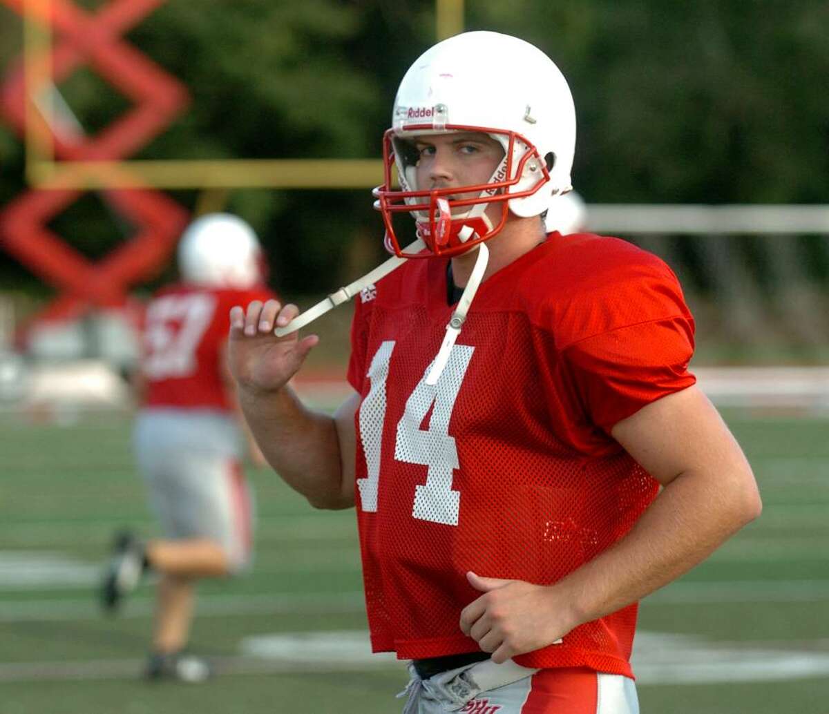 SHU football practice action in Fairfield, CT on Thursday Aug. 27, 2009. Here, QB #14 Dale Fink walks off the field for a break during a scrimage.