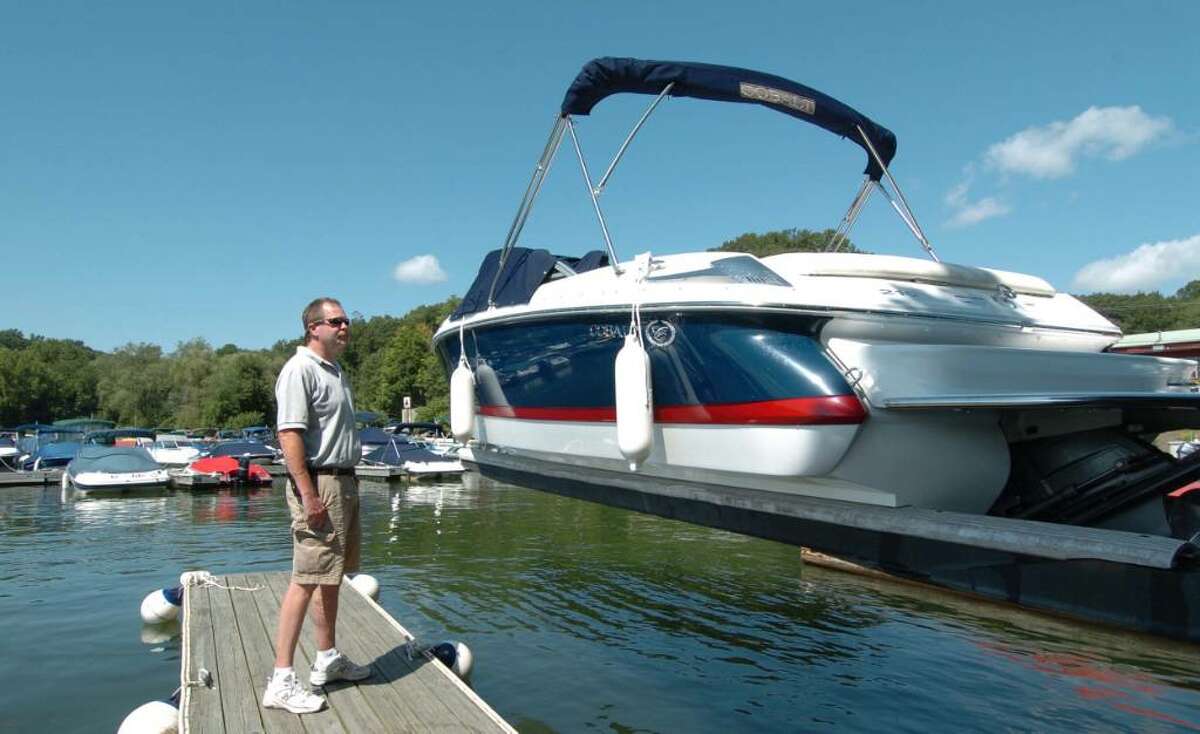 Chris Ware Staff Photographer. Mitch O'Hara Jr assists with lowering a customers boat into Candelwood East Marina August 14, 2009.