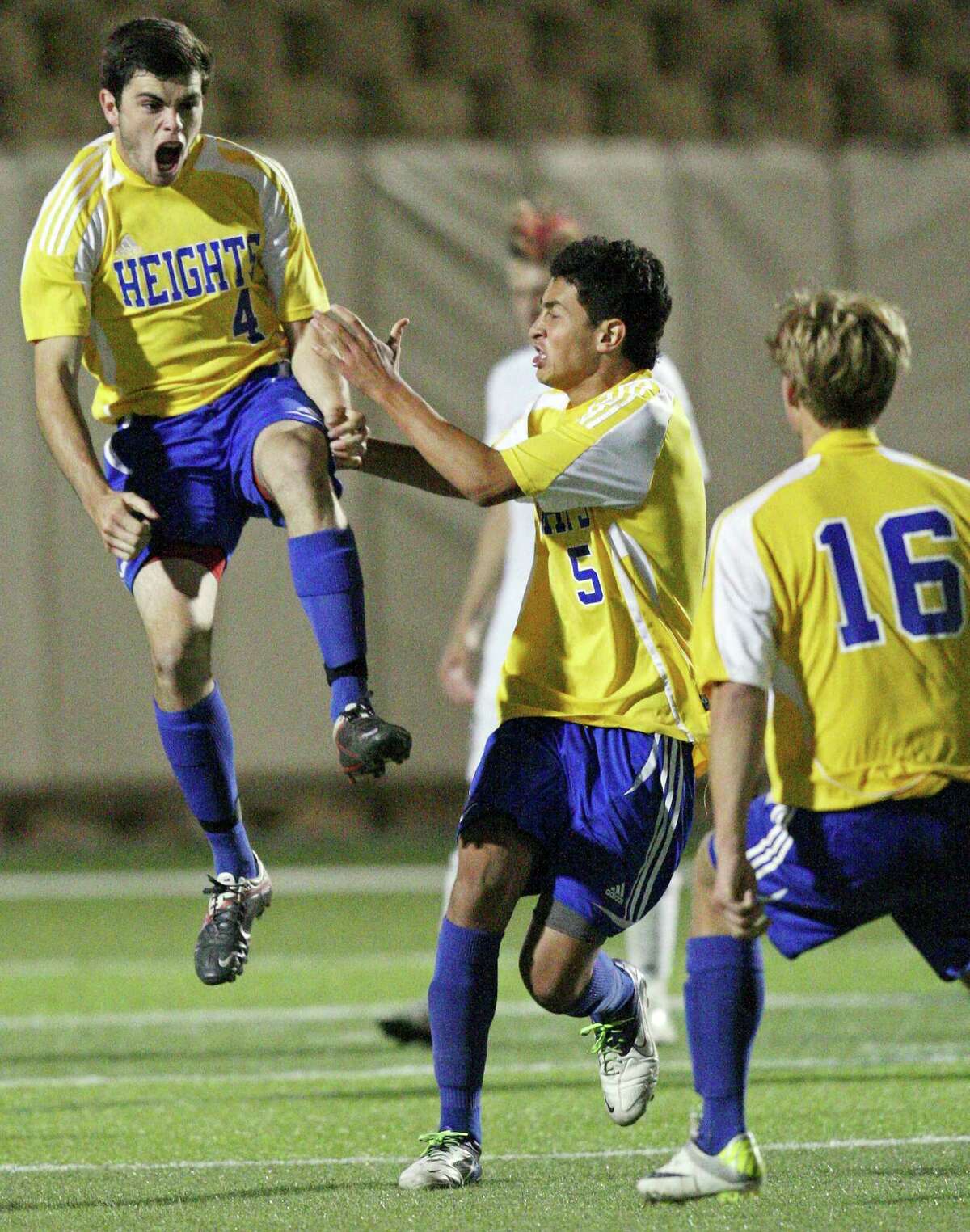 Alamo Heights' Alek Strimple (from left) celebrates with teammates Jesus Espin, and Robert Weigel after scoring against Wichita Falls Rider during overtime action of their Class 4A state final game Saturday, April 21, 2012 at Birkelbach Field in Georgetown. Alamo Heights won 3-2 in a shootout.