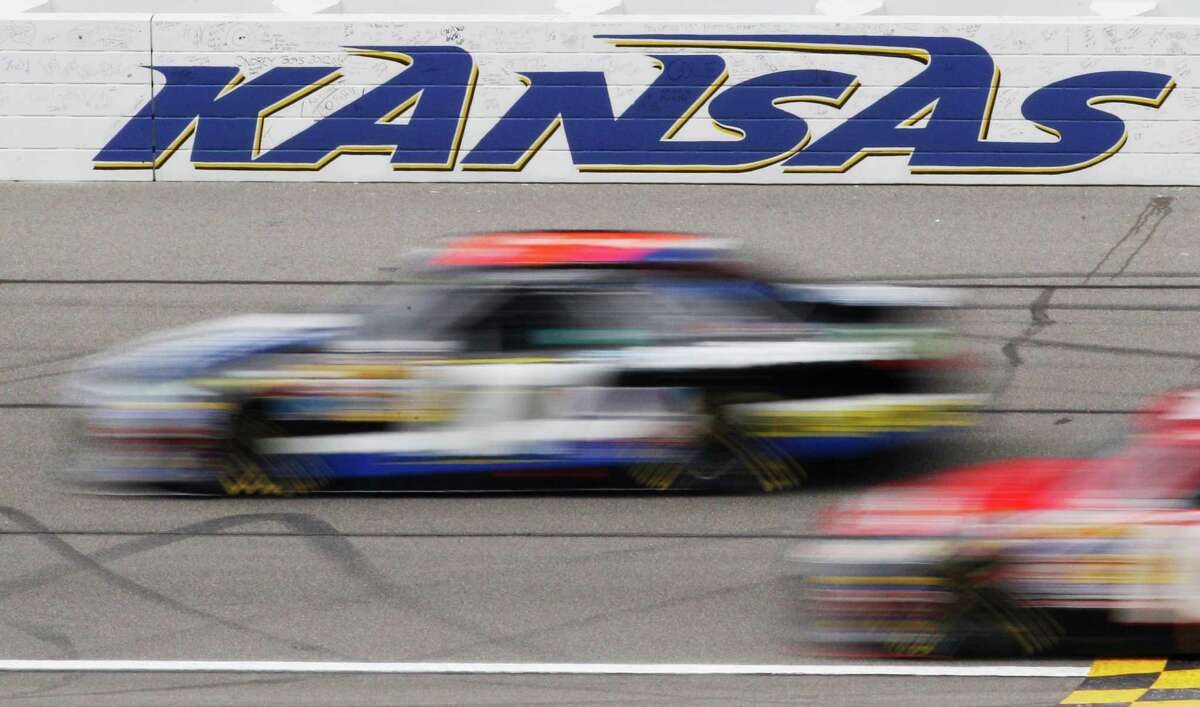 Drivers begin the first lap of the NASCAR Sprint Cup Series auto race at Kansas Speedway in Kansas City, Kan., Sunday, April 22, 2012. (AP Photo/Orlin Wagner)