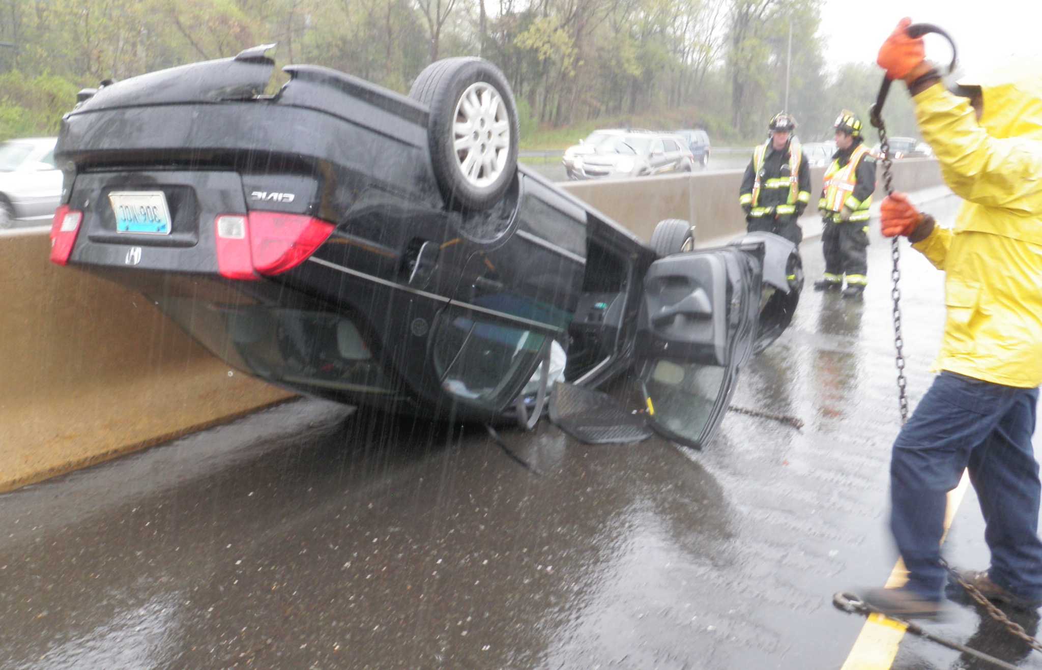 Car rolls over on wet I95 in Westport