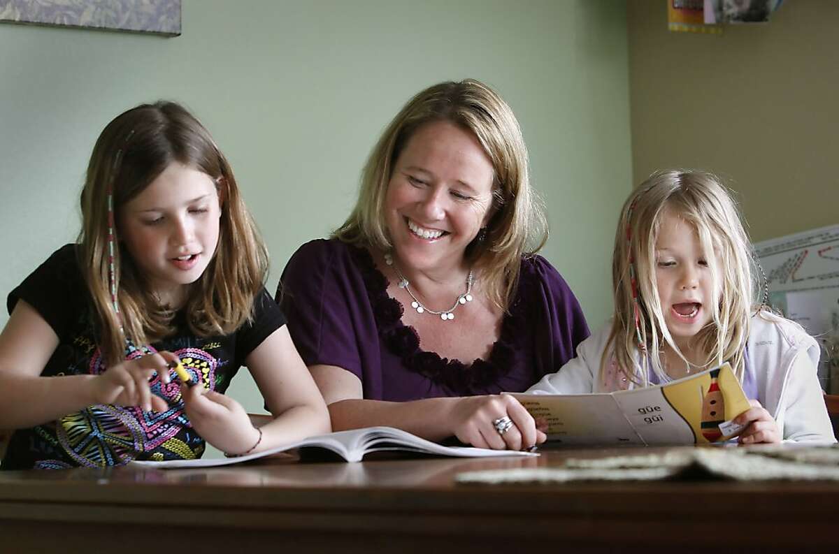 Raychel Kubby Adler with her two daughters, Marley, 9 and Ruby, 6 doing after school homework at their Davis, Ca. home, on Wednesday April 18, 2012. A year and a half after Raychel Kubby Adler discovered she carried a genetic mutation that gave her an 87 percent lifetime chance of developing breast cancer, she opted to have a prophylactic double mastectomy at age 36. She has a new online tool to help her weigh her options. Using the interactive tool, which was developed by Stanford University School of Medicine researchers, Kubby Adler learned her risk of developing ovarian cancer may remain relatively low whether she has the surgery now at age 40 or waits until sheís 45.