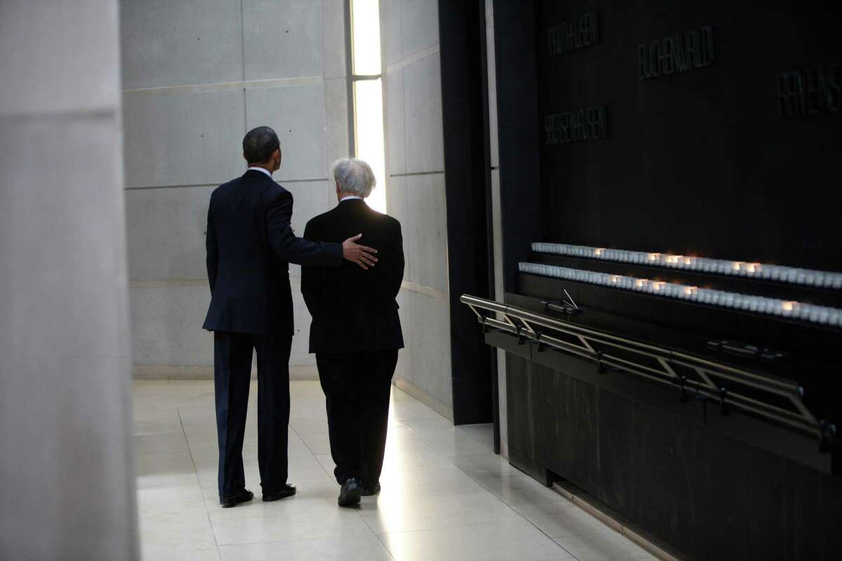 U.S. President Barack Obama (R) and Elie Wiesel walk in the Hall of Remembrance at the Holocaust Museum April 23, 2012 in Washington, DC. Obama reportedly announced a new sanctions March 23, on Iran and Syria for entities and people using technology to target citizens.