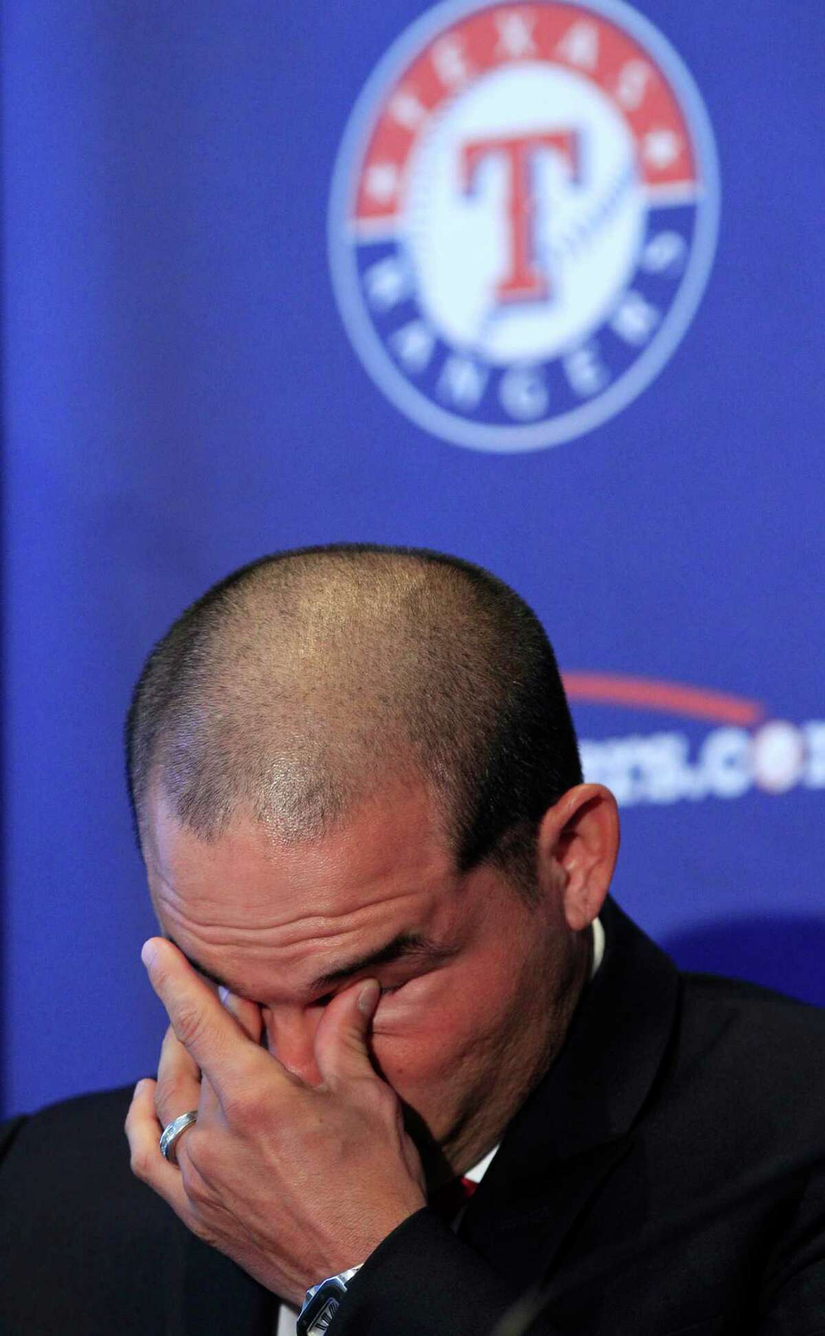 Former Texas Rangers Ivan Rodriguez fights back tears during an introduction for a news conference announcing his retirement as a baseball player, Monday, April 23, 2012, in Arlington, Texas. It came nearly 21 years after the fan favorite known as Pudge made his major league debut as a 19-year-old with the Rangers. (AP Photo/LM Otero)