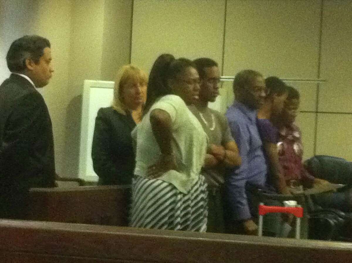 Prosecutors Dan Rodriguez and Jan Ischy stand to the side as murder victim Samuel Johnson Jr.'s fiancé, Erica Hinton (left) confronts Vanessa Cameron during a victim impact statement. Standing beside Hinton are Johnson's siblings and parents.