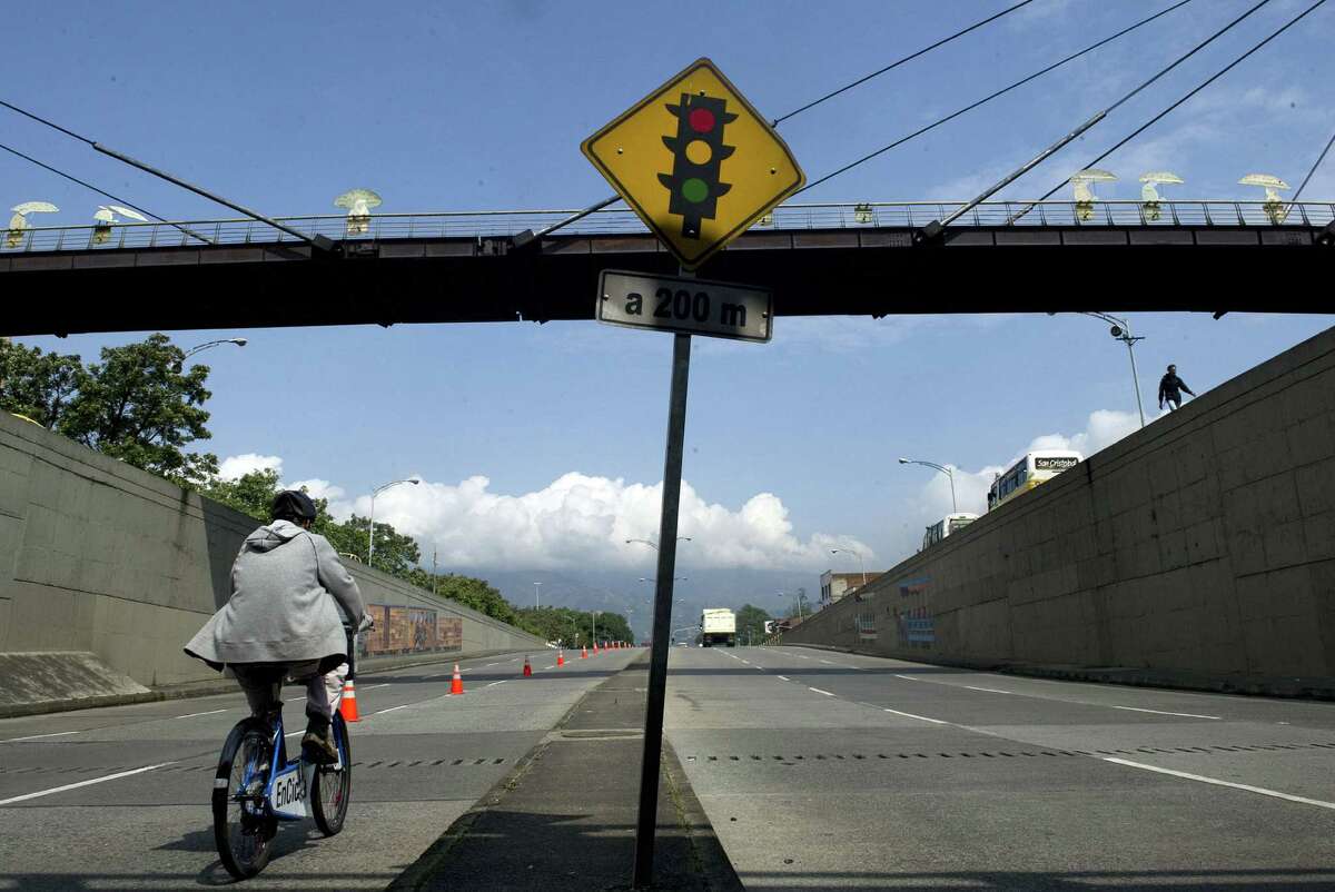 A man rides his bicycle in the framework of A Day Without Cars in Medellin, Antioquia department, Colombia on April 23, 2012. A municipal decree prohibited the use of private cars today, in an attempt to reduce pollution levels and to promote the use of public and alternative transport.