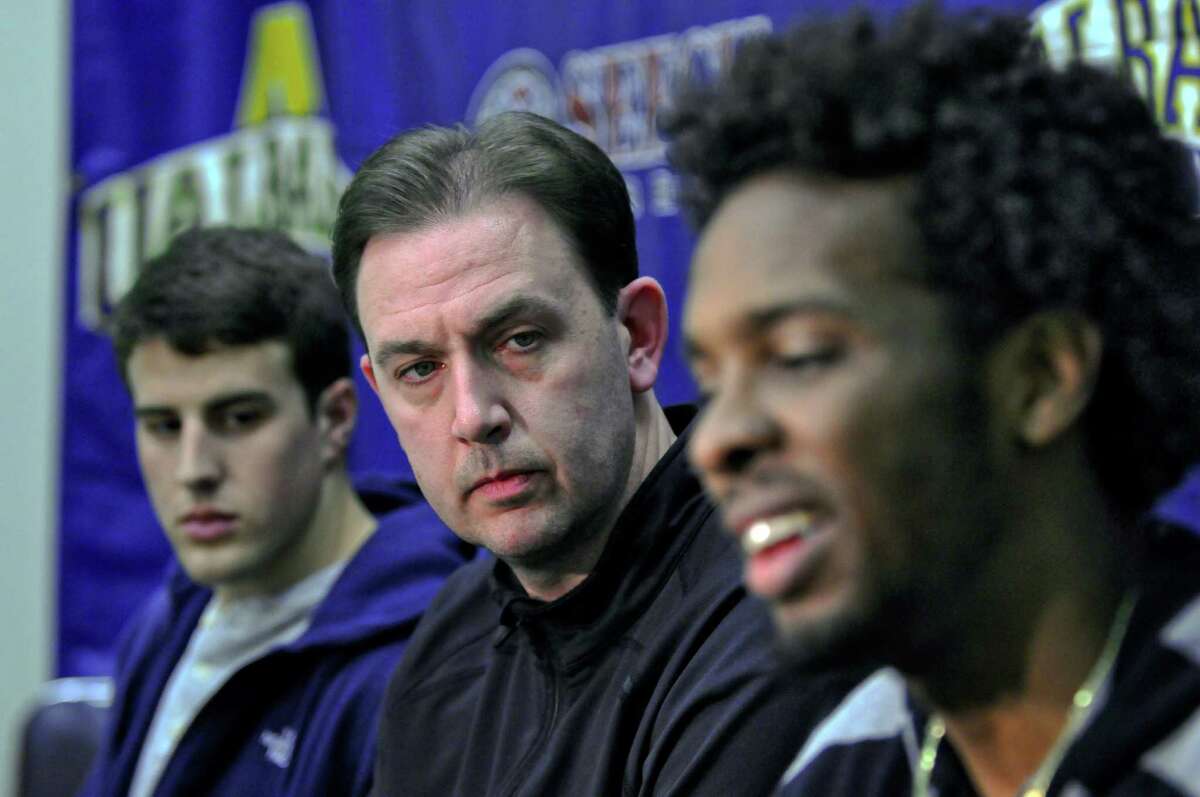 UAlbany men's basketball coach Will Brown, center, listens as players Gerardo Suero, right, and Logan Aronhalt, left, discuss their decisions to leave the program, on Monday April 23, 2012 in Albany, NY. Suero is turning professional, while Aronhalt is transferring primarily to continue his studies and to perhaps play again. (Philip Kamrass / Times Union )