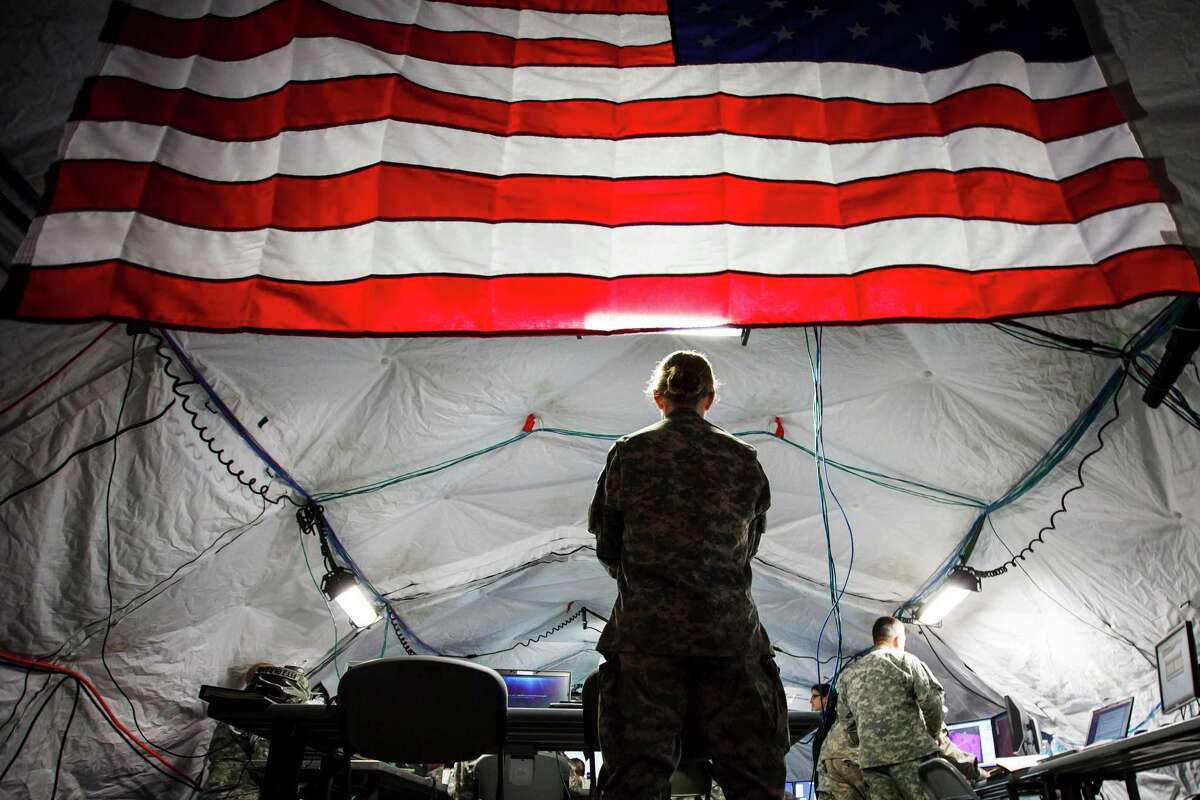 Members of the Fort Hood based 7th Battalion, 158th Aviation Regiment stand ready during a simulation exercise in a mobile Tactical Operation Center (TOC) at Ellington Field Joint Reserve Base at Ellington Airport, Monday, April 23, 2012, in Houston.