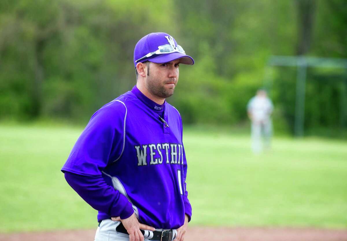 Westhill Coach DJ Mulvany watches as Westhill High School hosts Fairfield Warde in a baseball game in Stamford, Conn., April 24, 2012.