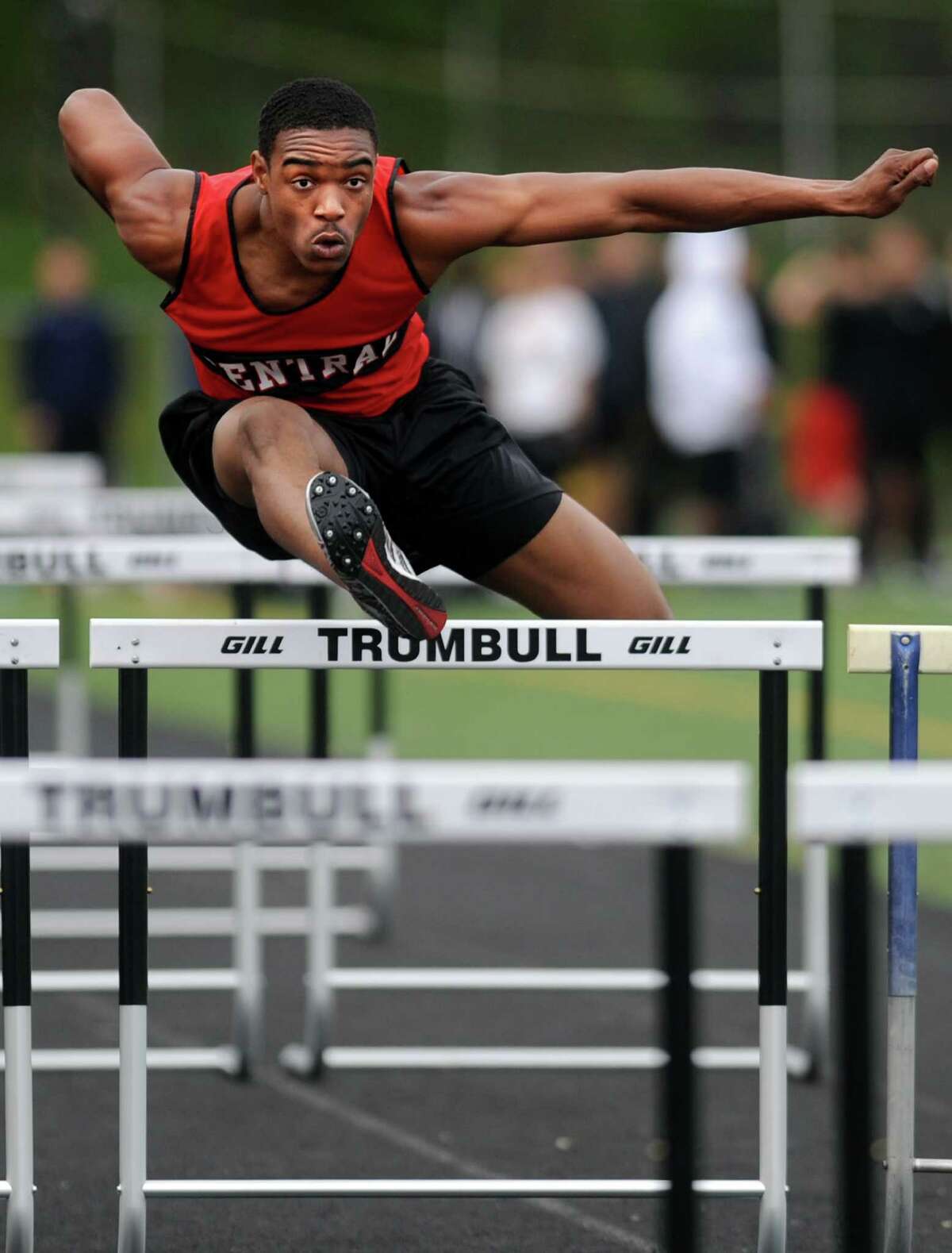 Central's Andre Aiken competes in the 110 meter hurdles Tuesday, April 24, 2012 during a track meet with Staples and Trumbull at Trumbull High School.
