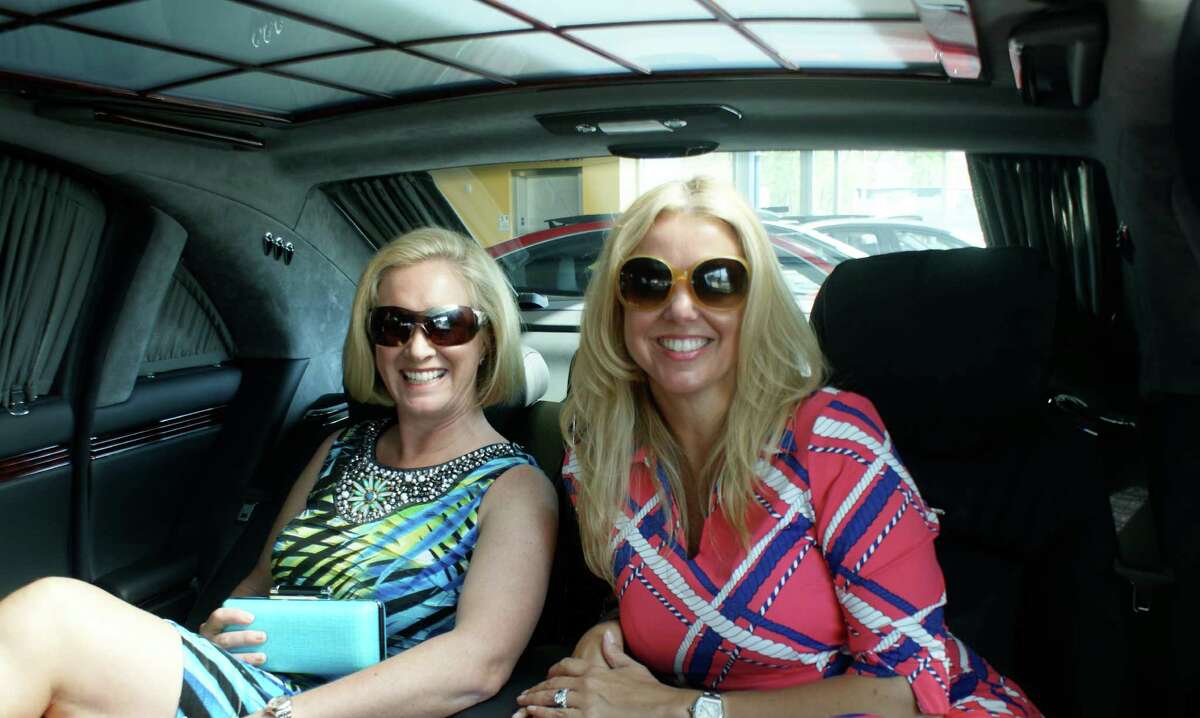 From left, Young Womenís League President Amy Burger and member Nancy Roeder pose in a Maybach at Mercedes-Benz of Greenwich, a sponsor for the upcoming Couture for a Cause fundraiser. Burger is wearing an outfit from Dorothy Mann and bag by Walin & Wolff. Roeder is wearing a look by J. McLaughlin.