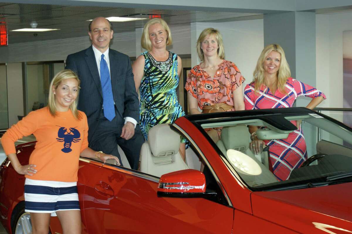 Young Womenís League member Jenn Shulman, Mercedes-Benz of Greenwich General Manager Lou Liodori, and YWL members Amy Burger, Amy Fields and Nancy Roeder pose in a Mercedes E550 at Mercedes-Benz of Greenwich, a sponsor for the upcoming Couture for a Cause fundraiser. The women are wearing fashions that will be featured at the May 4 event.