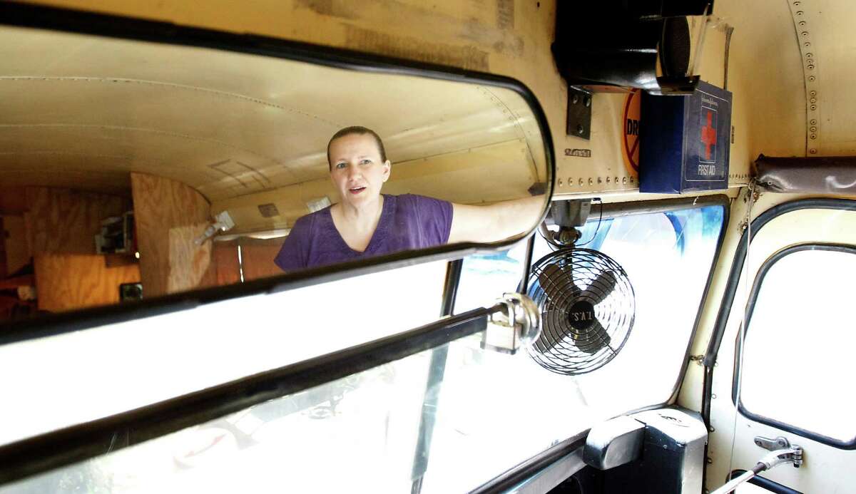 Sherrie Shorten, who just got out of jail eight days ago, stands inside of her home, a renovated school bus, Wednesday, April 25, 2012, in Splendora. Shorten, the mother of two children found living in a rundown school bus in Splendora while both she and her husband were incarcerated for embezzlement has completed her sentence and is fighting to regain her children from foster care. A hearing with Children's Protective Services is set for May 2 in Conroe and Shorten plans to be there. Authorities reported finding the children living in filthy conditions with smelly sewage overflows and little food on the premises. She has cleaned the bus and fixed the septic tank problems. the bus has a queen size bed, and bunk beds for the kids, as well as a computer and internet and a flat screen tv.