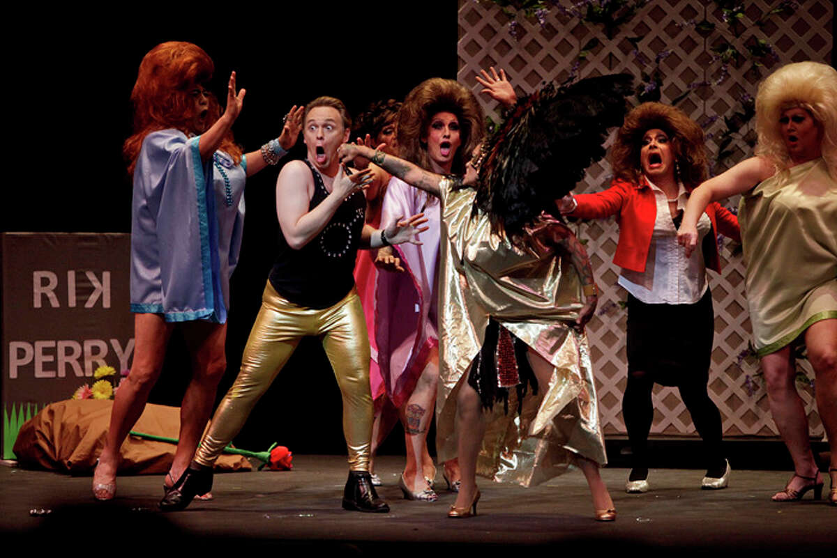 Tony Gloria, left, playing "Michele Bachmann's gay husband," gets "punched" by Chela Thomas, playing an Aztech Goddess, next to Darren Claus, playing Michele Bachmann, right, as they perform "The 3rd Rock From The Sun," The Duchess of Endless Divas, during Cornyation at the Charline McCombs Empire Theatre in San Antonio on Tuesday, April 24, 2012.