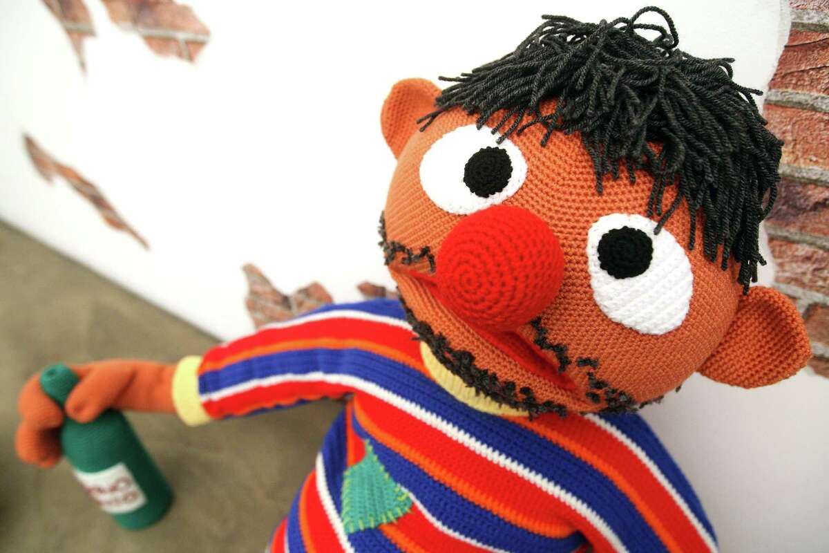 The knitted sculpture "Ernie" by Patricia Waller, featuring the children's television program star as a desperate alcoholic, sits in the "Broken Heroes" exhibition at the Deschler Gallery on April 26, 2012 in Berlin, Germany. The exhibition of hand-crocheted comic, puppet and cartoon figures shows icons of pop culture in various unfortunate states.