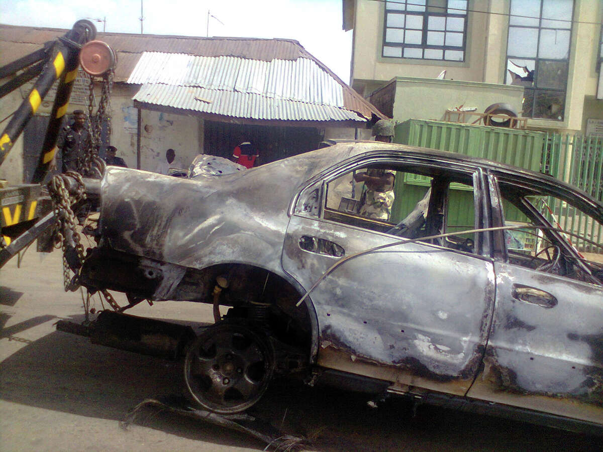 The vehicle used in a car bombing at a Nigerian newspaper is towed away from the scene in Kaduna, on April 26, 2012. A suicide attack at the Abuja bureau of a top Nigerian newspaper and a car bombing at another of its offices killed at least six people in the first such strikes against the country's media. The attack in the capital Abuja saw a suicide bomber drive into the back of the building belonging to ThisDay, one of the country's most prominent and influential, after security guards allowed him into the gate. AFP PHOTO/Victor UlasiVictor Ulasi/AFP/GettyImages