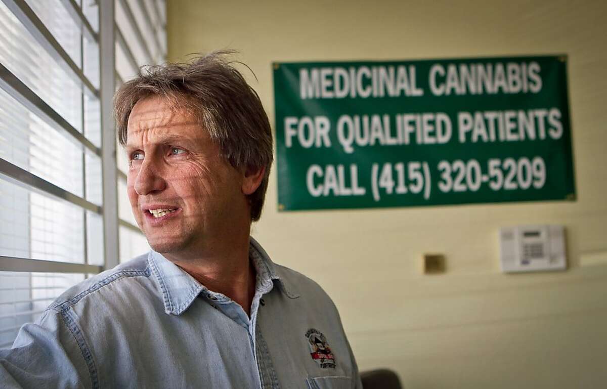Lawrence Pebbles looks at the window of his medical marijuana dispensary in Novato, Calif. on April 26th, 2012.