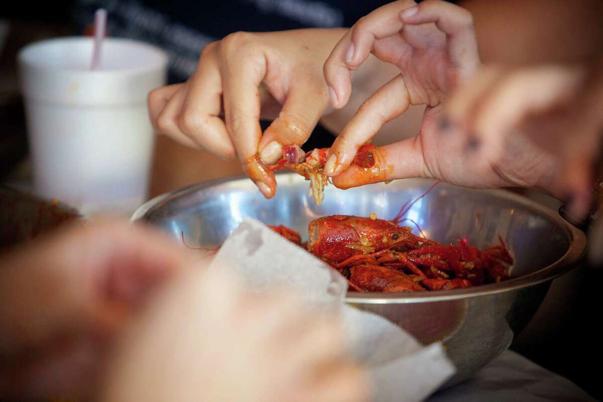 Guests tear into crawfish at Crawfish and Noodles.
