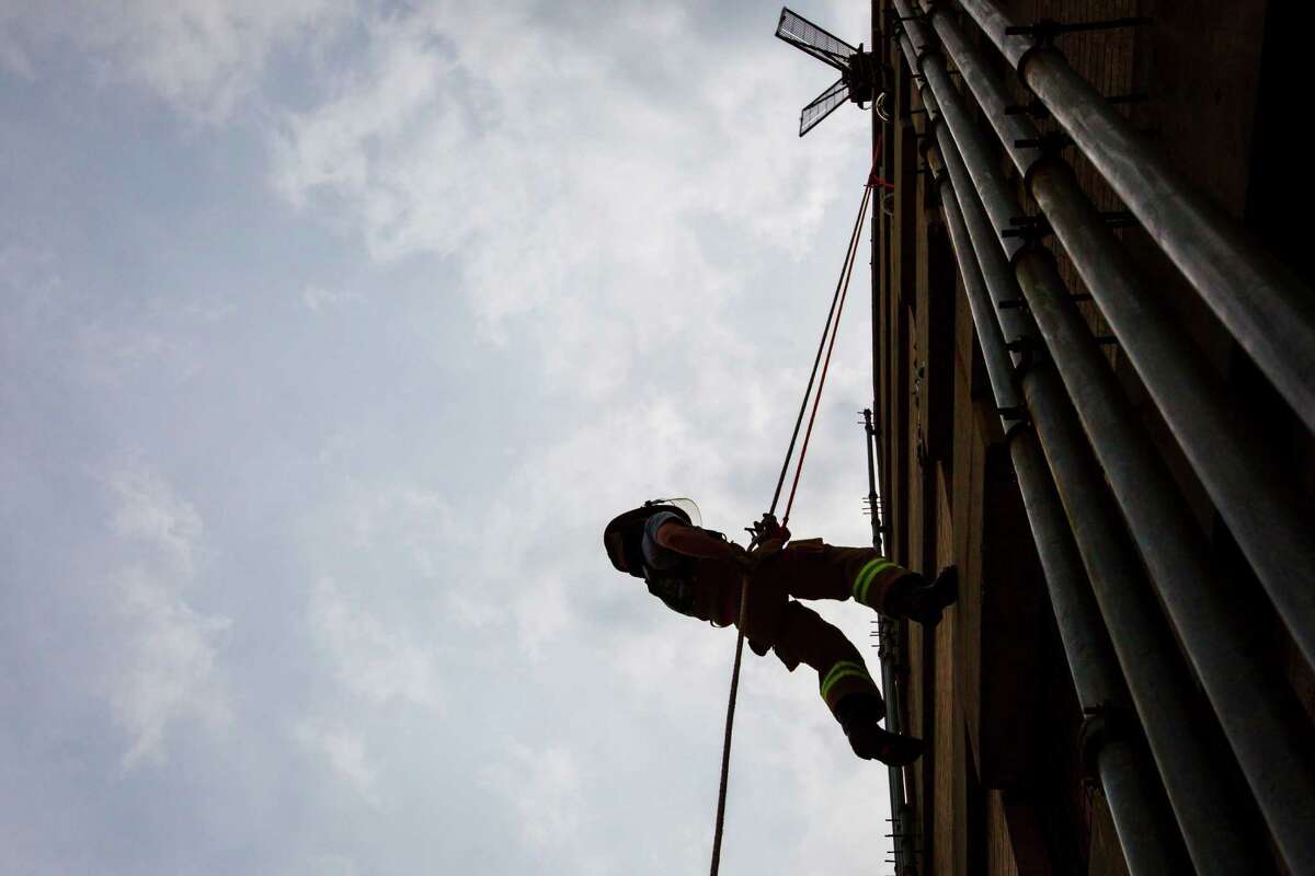 Jonathan Newport, Chief of Staff for Councilman Jack Christie, rappels down a 7-story Drill Tower during a rappelling exercise with fellow Council Members and City Council staff at the one-day fire department orientation course called "Fire Ops 101" at the Houston Fire Department Val Jahnke Training Academy, Friday, April 27, 2012, in Houston.