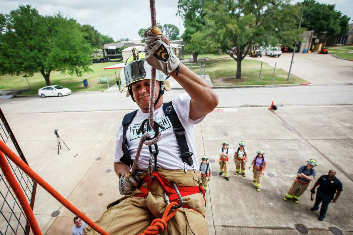 Houston City Council Member Ed Gonzalez rappels out of a second-story window during a rappelling exercise with fellow Council Members and City Council staff at the one-day fire department orientation course called "Fire Ops 101" at the Houston Fire Department Val Jahnke Training Academy, Friday, April 27, 2012, in Houston.