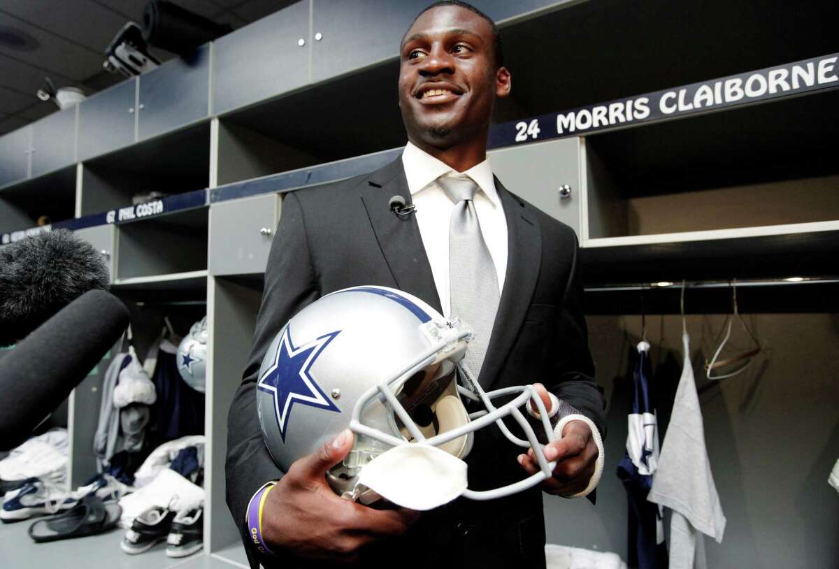 Cowboys first-round draft pick Morris Claiborne flashes a big smile as he stands in front of his new locker at Valley Ranch.