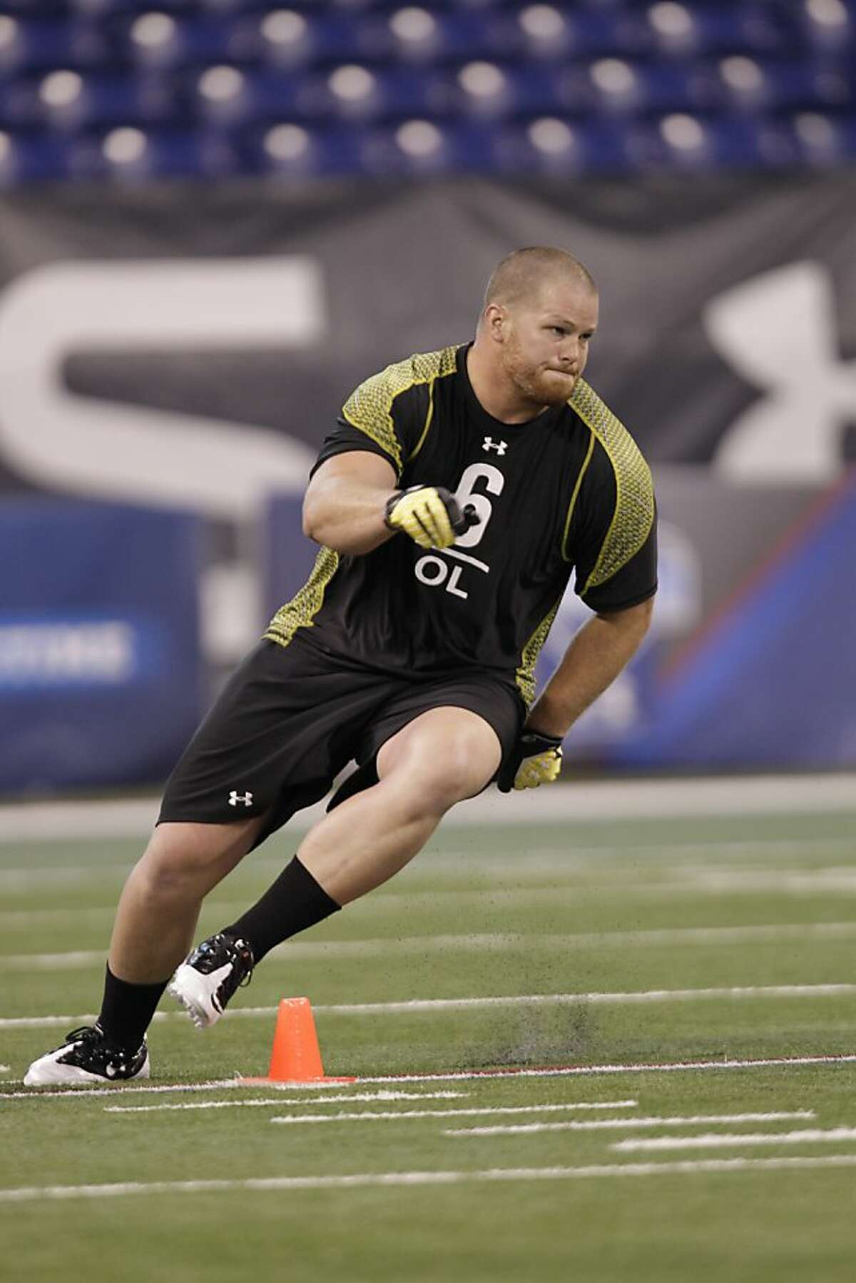 Utah offensive lineman Tony Bergstrom runs a drill at the NFL football scouting combine in Indianapolis, Saturday, Feb. 25, 2012.