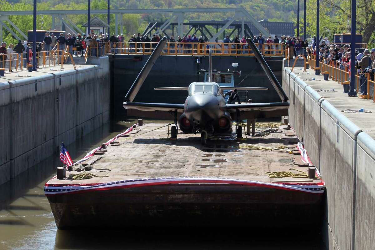 A vintage Douglas F-3D Skynight war plane from the Intrepid Sea, Air and Space Museum, passes through the Erie Canal lock 2, Saturday, April 28, 2012 in Waterford, N.Y. They are on their way to the Empire State Aerosciences Museum in Glenville, N.Y.