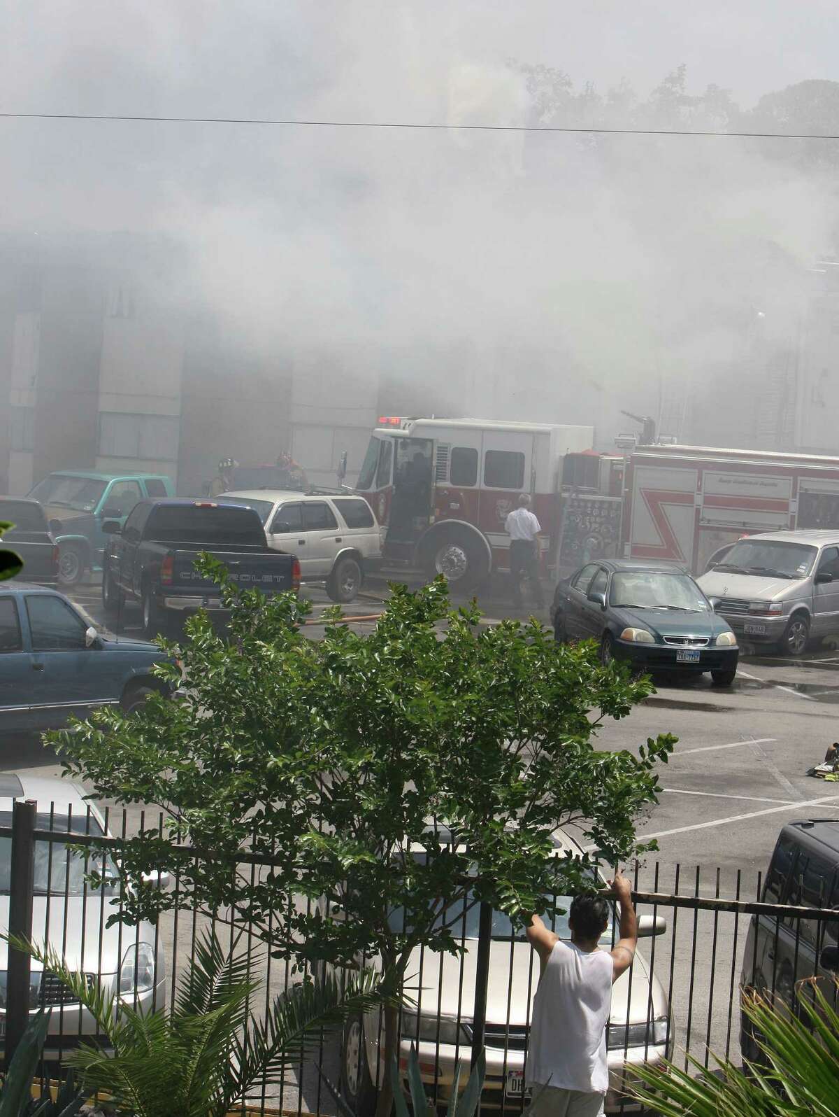 Houston Fire Department firefighters work to extinguish a three-alarm fire at the Long Point Place Apartment Homes in the 1700 block of Woodvine Saturday, April 28, 2012, in Houston.