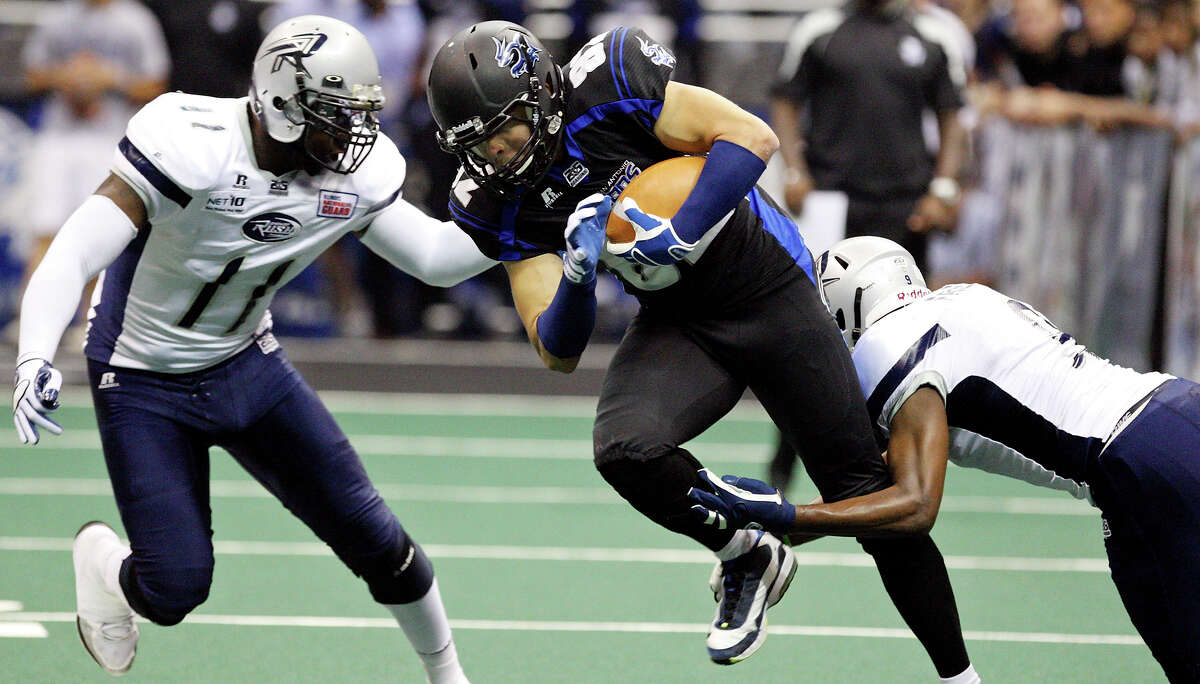 San Antonio Talons' Robert Quiroga looks for room between Chicago Rush's Kelvin Morris (left) and Chicago Rush's Brandon Freeman during first half action Saturday April 28, 2012 at the Alamodome. Quiroga will miss his eighth straight game for the Talons tonight.