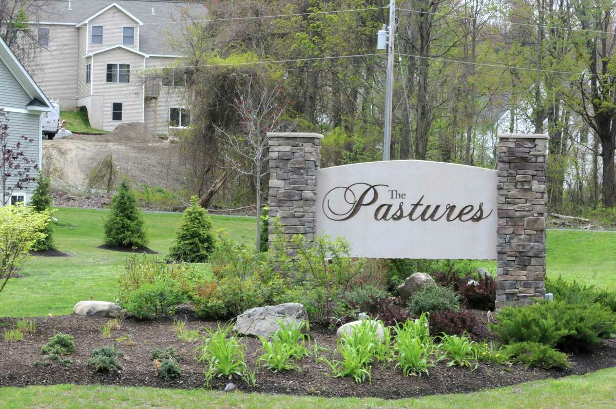Sign at the entrance to the new development "The Pastures" where National Grid is digging trenches for a new distribution gas line for the development Friday, April 27, 2012 in North Greenbush, N.Y. (Lori Van Buren / Times Union)